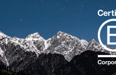 Starry sky over mountains with B Corp logo superimposed.
