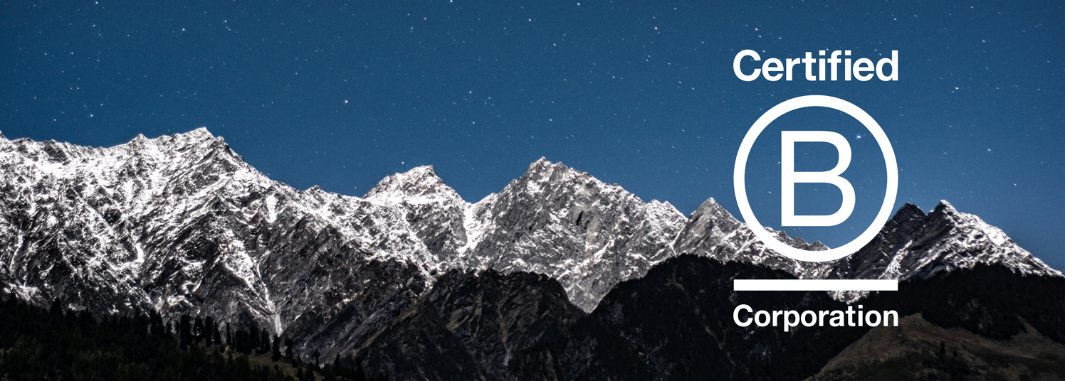 Starry sky over mountains with B Corp logo superimposed.