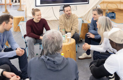 Group discussion in a seated circle at ISPO