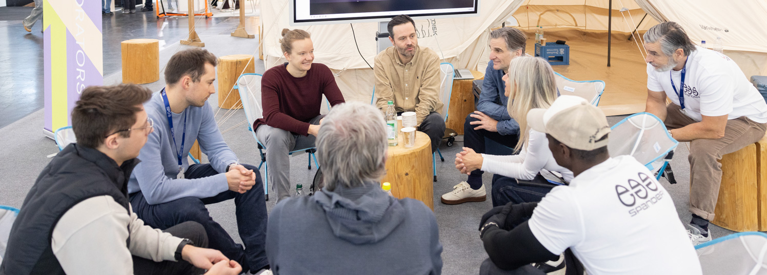 Group discussion in a seated circle at ISPO