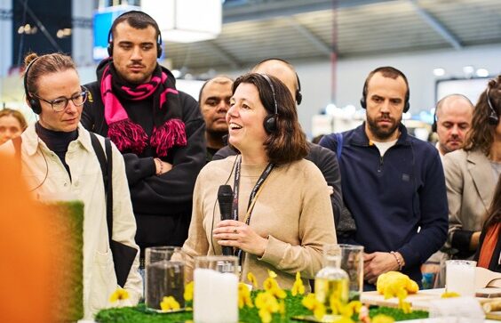 Speaker addressing visitors at a trade fair stand